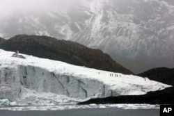 FILE - Members of the glaciology unit of Peru's national water authority walk on the Pastoruri glacier in Huaraz, Peru, Thursday, Dec. 4, 2014.
