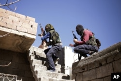 FILE - Militants from the Kurdistan Workers' Party, or PKK, maneuver to attack Turkish security forces in Nusaydin, Turkey, March 1, 2016.