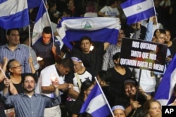 A demonstrator holds a sign that reads in Spanish "They took away so much that they even took away our fear," during a protest in remembrance of those who have died during anti-government protests in Managua, Nicaragua, April 25, 2018.