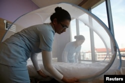 Nurses set up a mosquito tent over a hospital bed, as part of a precautionary protocol for patients who are infected by Zika at Farrer Park Hospital in Singapore Sept. 2, 2016