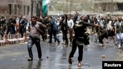 Afghans throw stones towards security forces during a protest in the wake of Wednesday's deadly bombing, in Kabul, Afghanistan, June, 2, 2017.