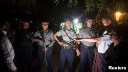FILE - Myanmar Police stand guard at the forensic department of a hospital where the body of Ko Ni is kept, in Yangon, Jan. 29, 2017.