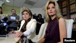 Summer Zervos, a former contestant on the TV show "The Apprentice," reacts next to lawyer Gloria Allred, left, while speaking about allegations of sexual misconduct against Donald Trump during a news conference in Los Angeles, Oct. 14, 2016.
