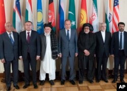 FILE - Russian Foreign Minister Sergey Lavrov (C) poses for a photo with participants of a conference on Afghanistan, in Moscow, Russia, Nov. 9, 2018.