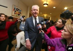 Starbucks CEO Kevin Johnson, center, walks towards a meeting with Philadelphia Mayor Jim Kenney and other officials Monday April 16, 2018, at Philadelphia City Hall.