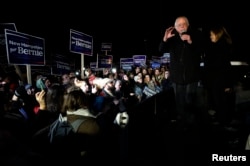 U.S. Democratic presidential candidate Bernie Sanders, with his wife Jane, addressess supporters from the bed of a pickup truck after arriving early morning in Bow, New Hampshire, from Iowa, Feb. 2, 2016.