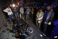 People gather near the site of a twin suicide attack in Burj al-Barajneh, southern Beirut, Lebanon, Nov. 12, 2015.
