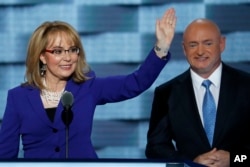 FILE - Former Rep. Gabby Giffords, D-Ariz., and her husband, retired astronaut Mark Kelly, speak during the third day of the Democratic National Convention in Philadelphia, July 27, 2016.