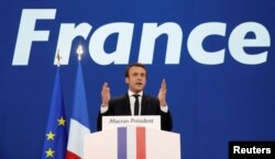 Emmanuel Macron, head of the political movement En Marche !, or Onwards !, and candidate for the 2017 French presidential election, gestures to supporters after the first round of 2017 French presidential election in Paris, April 23, 2017.