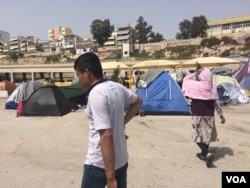 The Greek government says it will close settlements on the port that house thousands of people. Many say they don't plan to go to "official" camps for fear of worse conditions or being detained, taken in Athens, Greece on April, 8, 2016. (H. Murdock / VO