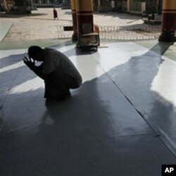 A Burmese man prays at a temple in Bago, northeast of Rangoon, on Election Day.