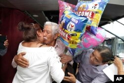 Luis Mendez Chanes, center, is reunited with his daughter Marta Mendez who he hasn't seen in 24-years, and her husband Luis Flores, from Queens, as they ride the Bateaux New York boat, July 5, 2017 in New York.
