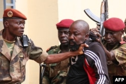 FILE - Members of the armed forces arrest Central African Republic MP Alfred Yekatom after he fired a gun at the parliament in Bangui, Oct. 29, 2018.