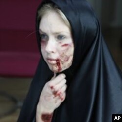 An activist of the women's rights group Femen prepares for a protest against domestic violence in Istanbul, March 8, 2012.