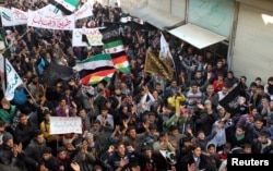 FILE - Demonstrators protest Syria's President Bashar al-Assad in Aleppo's al-Sha'ar district, Jan. 25, 2013.