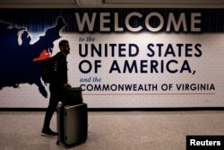 FILE - An international passenger arrives at Washington Dulles International Airport in Virginia.