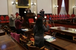 The three members of Vermont's Electoral College, Terje Anderson, left, Linda Gravell, center, and Kesha Ram, take the oath of office from Secretary of State Jim Condos at the Statehouse in Montpelier, Vt., on Monday, Dec. 14, 2020. (AP Photo/Wilson Ring)