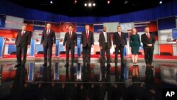 FILE - Republican presidential candidates John Kasich, Jeb Bush, Marco Rubio, Donald Trump, Ben Carson, Ted Cruz, Carly Fiorina and Rand Paul take the stage before the Republican presidential debate at the Milwaukee Theatre, Nov. 10, 2015, in Milwaukee.