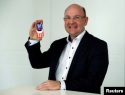 Le PDG de Nokia Florian Seiche pose avec le téléphone 3310 à Londres, Grande-Bretagne, le 24 février 2017.