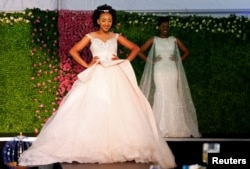 A model presents a wedding gown creation before a TV broadcast of Britain's Prince Harry and Meghan Markle's royal wedding at the Windsor Golf Hotel and Country Club in Nairobi, Kenya, May 19, 2018.