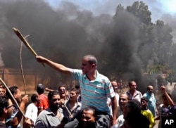 Egyptians chant slogans during clashes between supporters and opponents of Egypt's president and his Muslim Brotherhood in Luxor, Egypt, June 19, 2013.
