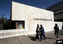 FILE - A Syrian patient, who was wounded in the ongoing conflict in Syria, walks outside The Rebecca Sieff Government Hospital, also known as the Ziv Hospital, in the northern Israeli town of Safed on March 10, 2016.