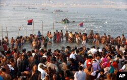 Indian Hindu devotees gather to take holy dips at Sangam, the confluence of the Rivers Ganges, Yamuna and mythical Saraswati on Maghi Purnima, or the full-moon day of the month during the annual "Magh Mela" fair in Allahabad, Feb. 10, 2017.