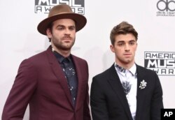 Alex Pall, left, and Andrew Taggart, of The Chainsmokers, arrive at the American Music Awards at the Microsoft Theater in Los Angeles.
