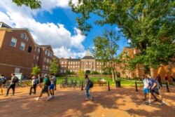 Students walk across the Oxford, Ohio campus of Miami University.