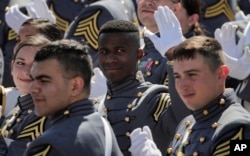 Cadets turn to wave at family members during graduation ceremonies last month at West Point, New York.