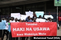 Several dozen protesters march to the electoral commission offices demanding an investigation into the murder of Independent Electoral and Boundaries Commission senior official Chris Msando, in Nairobi, Aug. 1, 2017.