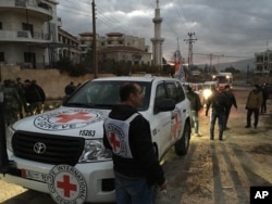 FILE - This picture provided by The International Committee of the Red Cross, working alongside the Syrian Arab Red Crescent (SARC) and the United Nations, shows a convoy containing food, medical items, blankets and other materials being delivered to the town of Madaya.