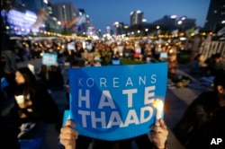 FILE - South Korean protesters stage a rally to oppose a plan to deploy the advanced U.S. missile defense system called Terminal High-Altitude Area Defense, or THAAD, near U.S. Embassy in Seoul, South Korea, April 29, 2017.