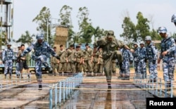 Chinese and Russian soldiers take part in a joint military drill in Zhanjiang, Guangdong province, China, Sept. 13, 2016.