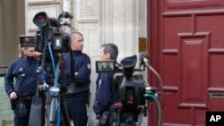 French police officers stand outside the residence of Kim Kardashian West in Paris Monday, Oct. 3, 2016. Kim Kardashian West was unharmed after being robbed at gunpoint of more than $10 million worth of jewelry inside a private Paris residence Sunday nigh