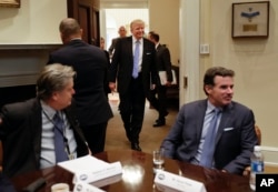 President Trump walks into meeting Monday with business leaders.