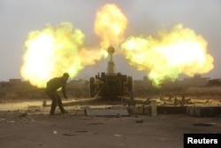 Popular Mobilization Forces fire toward Islamic State militants during a battle on the outskirts of al-Ba'aj, west of Mosul, Iraq, May 26, 2017.