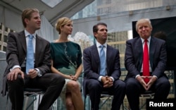 FILE - Donald Trump (R) along with his children Eric (L), Ivanka (2nd L) and Donald Jr. attend a ceremony announcing a new hotel and condominium complex in Vancouver, British Columbia, June 19, 2013.
