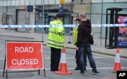 Police block a road near to the Manchester Arena in central Manchester, England, May 23, 2017. An explosion struck an Ariana Grande concert attended by thousands of young music fans in northern England late Monday, killing over a dozen people and injuring