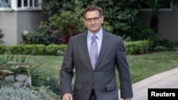 Jeffrey Newman comes out of his home to make a brief comment about his father, Merrill Newman, an 85-year-old Korean War veteran being detained by North Korean authorities, in Pasadena, California, Nov. 22, 2013.