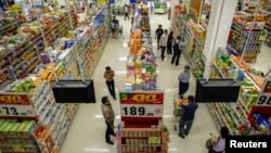 FILE - People shop in a supermarket inside a department store in Bangkok.