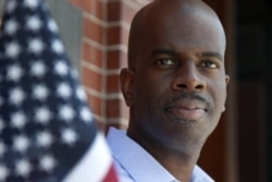 In this June 12, 2020, photo, Gregory Minott stands in front of Town Hall in Andover, Massachusetts.