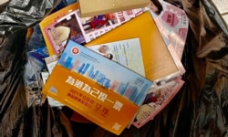 距离新选制下首次香港立法会换届选举还有倒数6日，港岛区一幢住宅大厦的垃圾桶内，居民丢弃不少选举宣传单张 (美国之音汤惠芸)