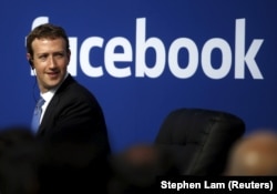 FILE - Facebook CEO Mark Zuckerberg is seen on stage during a town hall at Facebook's headquarters in Menlo Park, California, Sept. 27, 2015.