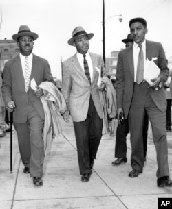 FILE - The Rev. Ralph Abernathy (L), Rev. Dr. Martin Luther King, Jr. (C), and Bayard Rustin, leaders in the racial bus boycott in Montgomery, Ala., leave the Montgomery County Courthouse on Feb. 24, 1956.