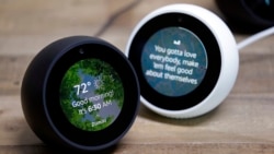 In this Wednesday, Sept. 27, 2017, file photo, Amazon Echo Spots are displayed during a program announcing several new Amazon products by the company, in Seattle. (AP Photo/Elaine Thompson, File)