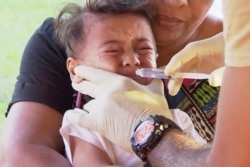 In this November 2019, image from video, a child gets vaccinated against measles at a health clinic in Apia, Samoa.