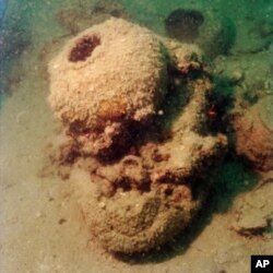 Submerged underwater for centuries, this storage jar from the Tang treasures eventually became an integral part of a coral formation.