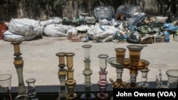 Glass piles up waiting to be melted near the workshop, where there is also a shop selling glassware.