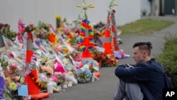 In this March 18, 2019, file photo, a student pays his respects at a park outside the Al Noor mosque in Christchurch, New Zealand. (AP Photo/Vincent Yu, File)
